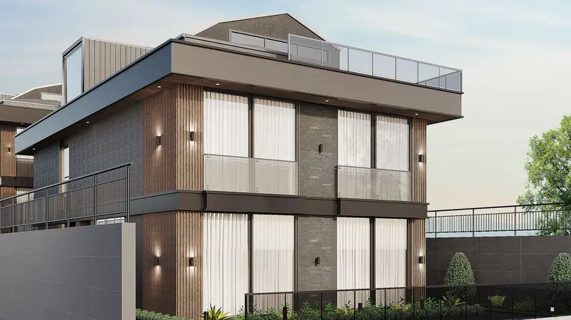 Kavaklı Gürpınar'da ahşap çıtalar, kayrak taşı şeritler ve cam korkuluklu balkonlarla antrasit villa cephesi